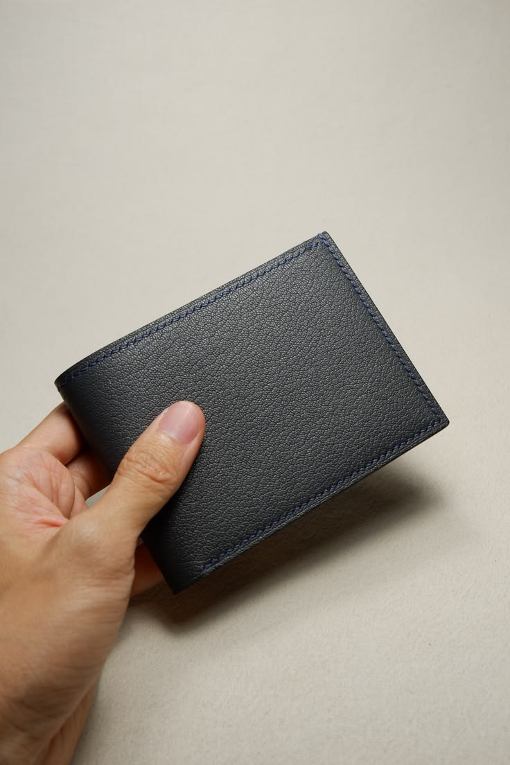 Finished bifold wallet held in hand