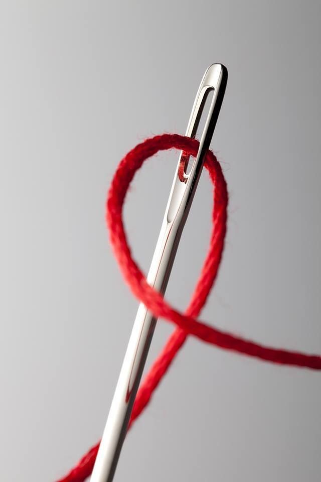 Hand-sewing needle threaded with waxed linen